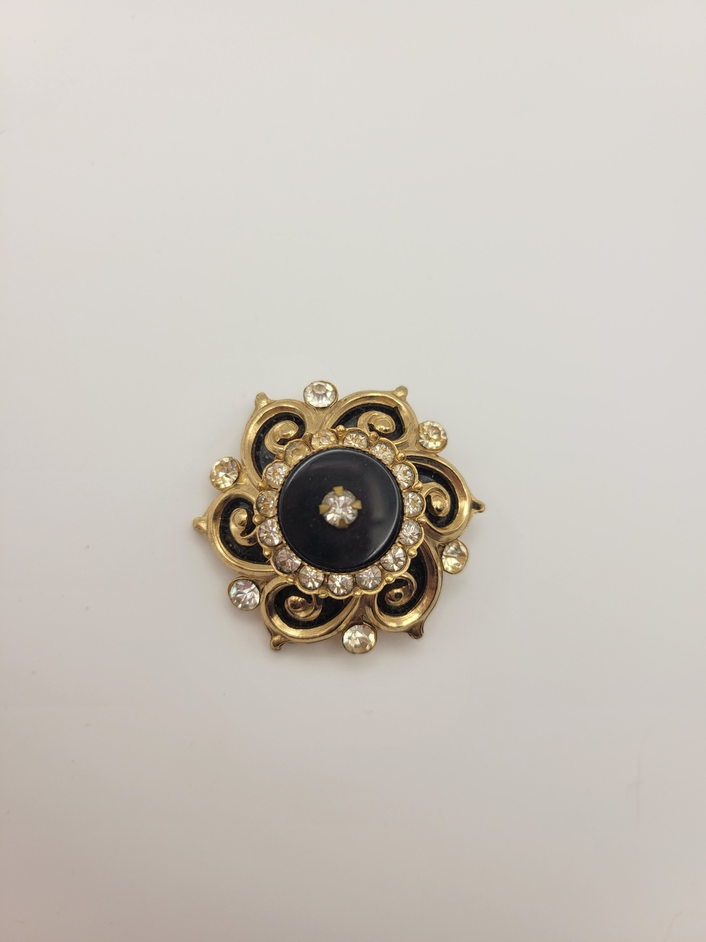 Vintage unmarked black glass and clear stone flower brooch